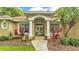 Elegant front entrance showcasing decorative columns, lush landscaping, and a welcoming walkway to the front door at 3717 Tigereye Ct, Mulberry, FL 33860