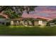 Charming home boasts a manicured lawn, complemented by a beige facade and a walkway to the welcoming front door at 3717 Tigereye Ct, Mulberry, FL 33860