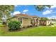 Charming one-story home featuring a manicured lawn, lush landscaping and a welcoming front entrance with columns at 3717 Tigereye Ct, Mulberry, FL 33860