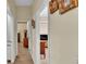 Hallway with light-colored walls and modern floors that connects multiple rooms in the home at 3717 Tigereye Ct, Mulberry, FL 33860