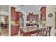 Kitchen with island with bar seating, stainless appliances, and dark cabinets at 3717 Tigereye Ct, Mulberry, FL 33860