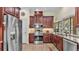 Kitchen with stainless appliances, dark wood cabinets, and light countertops at 3717 Tigereye Ct, Mulberry, FL 33860