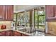 Kitchen sink with large window looking out onto a screened in lanai at 3717 Tigereye Ct, Mulberry, FL 33860