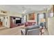 Cozy living room featuring a ceiling fan, a leather sofa and an entertainment center at 3717 Tigereye Ct, Mulberry, FL 33860