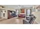 Comfortable living room showcasing a ceiling fan, a leather sofa, and a wooden entertainment center at 3717 Tigereye Ct, Mulberry, FL 33860