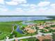 Stunning aerial view of a beautiful community, featuring a lake, a golf course, and lovely homes at 4105 Limerick Dr, Lake Wales, FL 33859