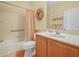 Bright bathroom featuring a shower over tub, wood look floors and neutral colored walls at 4105 Limerick Dr, Lake Wales, FL 33859