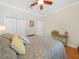 The comfortable bedroom features a ceiling fan, wood floors, and closet storage for organization at 4105 Limerick Dr, Lake Wales, FL 33859