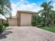Charming home exterior with a paved driveway, manicured landscaping, and a two-car garage at 4105 Limerick Dr, Lake Wales, FL 33859