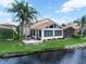Stunning exterior showcasing a well-maintained home with beautiful landscaping and a tranquil pond at 4105 Limerick Dr, Lake Wales, FL 33859
