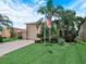 Beautiful home with a lush green lawn, palm trees, and a spacious driveway leading to a two-car garage at 4105 Limerick Dr, Lake Wales, FL 33859