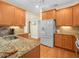 Modern kitchen with granite countertops, stainless steel appliances, and ample cabinet space at 4105 Limerick Dr, Lake Wales, FL 33859