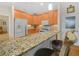 The kitchen features a granite breakfast bar, stainless steel appliances, and ample wood cabinet storage at 4105 Limerick Dr, Lake Wales, FL 33859