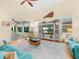 Bright living room with a vaulted ceiling, ceiling fan and view of the lanai through sliding doors at 4105 Limerick Dr, Lake Wales, FL 33859