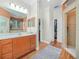 This main bathroom boasts plenty of vanity storage, neutral paint, and a doorway to the shower at 4105 Limerick Dr, Lake Wales, FL 33859