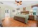 This main bedroom offers wood floors, a ceiling fan, and neutral paint for a relaxing atmosphere at 4105 Limerick Dr, Lake Wales, FL 33859