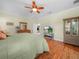The spacious main bedroom has wood floors and a ceiling fan, creating a bright, relaxing retreat at 4105 Limerick Dr, Lake Wales, FL 33859