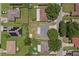 A home's overhead view featuring mature trees, a large backyard, and residential street access at 411 Red Hawk Loop, Winter Haven, FL 33880