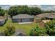 Aerial view showcasing the property's backyard, landscaping, sheds and proximity to neighboring homes at 411 Red Hawk Loop, Winter Haven, FL 33880