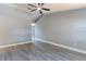 Spacious room with gray walls, white trim, wood-look floors, and a ceiling fan at 411 Red Hawk Loop, Winter Haven, FL 33880