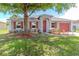 Charming home boasts mature shade tree and is beautifully landscaped at 411 Red Hawk Loop, Winter Haven, FL 33880