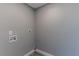 Laundry room with light gray walls, wood-look flooring, and water hookups at 411 Red Hawk Loop, Winter Haven, FL 33880