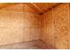 Interior view of a shed, featuring unfinished wood walls, bare studs, and a plywood floor at 411 Red Hawk Loop, Winter Haven, FL 33880