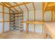 Shed interior equipped with shelving and a workbench for storage and projects at 411 Red Hawk Loop, Winter Haven, FL 33880
