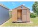 An outdoor shed with an open door, showing its storage capacity and accessibility at 411 Red Hawk Loop, Winter Haven, FL 33880