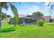 Private backyard featuring a screened-in pool, patio area, and lush green lawn at 419 Wellesly Dr, Davenport, FL 33897