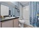 Cozy bathroom featuring a shower and bathtub combination with light wood cabinets at 419 Wellesly Dr, Davenport, FL 33897