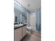 This is a well-lit bathroom featuring a shower, bath tub, and light wood cabinets at 419 Wellesly Dr, Davenport, FL 33897