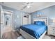 Bedroom featuring a white bed frame, a fan, and a closet with blue walls at 419 Wellesly Dr, Davenport, FL 33897