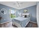 Bright bedroom featuring a ceiling fan, a window with natural light, and light blue walls at 419 Wellesly Dr, Davenport, FL 33897