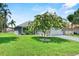 Charming home featuring a well-manicured lawn and mature tree, adding to its curb appeal at 419 Wellesly Dr, Davenport, FL 33897