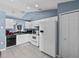 Functional kitchen with white appliances, ample cabinet space, and tiled floor at 419 Wellesly Dr, Davenport, FL 33897