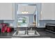 Kitchen sink with view to backyard pool and patio at 419 Wellesly Dr, Davenport, FL 33897