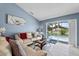 Comfortable living room with view of pool through glass sliding doors at 419 Wellesly Dr, Davenport, FL 33897
