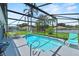 Screened-in pool area with outdoor seating and lush landscaping for relaxing at 419 Wellesly Dr, Davenport, FL 33897