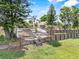 Tiered backyard features a wooden staircase, lush lawn, and mature landscaping at 452 Lake Suzanne Dr, Lake Wales, FL 33859