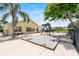 The backyard has lush landscaping, a swing set, and a seating area with lake views at 452 Lake Suzanne Dr, Lake Wales, FL 33859