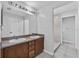 Bathroom featuring double sinks, a large mirror, and a walk-in shower at 452 Lake Suzanne Dr, Lake Wales, FL 33859