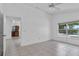 Bright bedroom featuring tile flooring, ceiling fan, and a window with a view at 452 Lake Suzanne Dr, Lake Wales, FL 33859