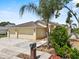Well-maintained home featuring a spacious three car garage, lush landscaping, and charming curb appeal at 452 Lake Suzanne Dr, Lake Wales, FL 33859