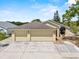 Charming single-story home featuring a three-car garage and well-manicured landscaping at 452 Lake Suzanne Dr, Lake Wales, FL 33859