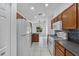 Functional kitchen design with white appliances, tile backsplash, and wood cabinetry at 452 Lake Suzanne Dr, Lake Wales, FL 33859