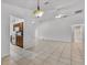 Spacious living room featuring view into the kitchen, a ceiling fan and easy access to other rooms at 452 Lake Suzanne Dr, Lake Wales, FL 33859