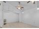 Empty living room featuring tiled floors and multiple ceiling fans at 452 Lake Suzanne Dr, Lake Wales, FL 33859