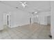 Spacious living room featuring neutral tile flooring, ceiling fans and easy access to other rooms at 452 Lake Suzanne Dr, Lake Wales, FL 33859