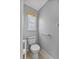 Small toilet room with natural light, window blinds and tile floors at 452 Lake Suzanne Dr, Lake Wales, FL 33859